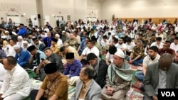 Indonesian diaspora Muslims in Washington DC, United States, listening to a sermon after Eid prayers, Tuesday, June 4, 2019.